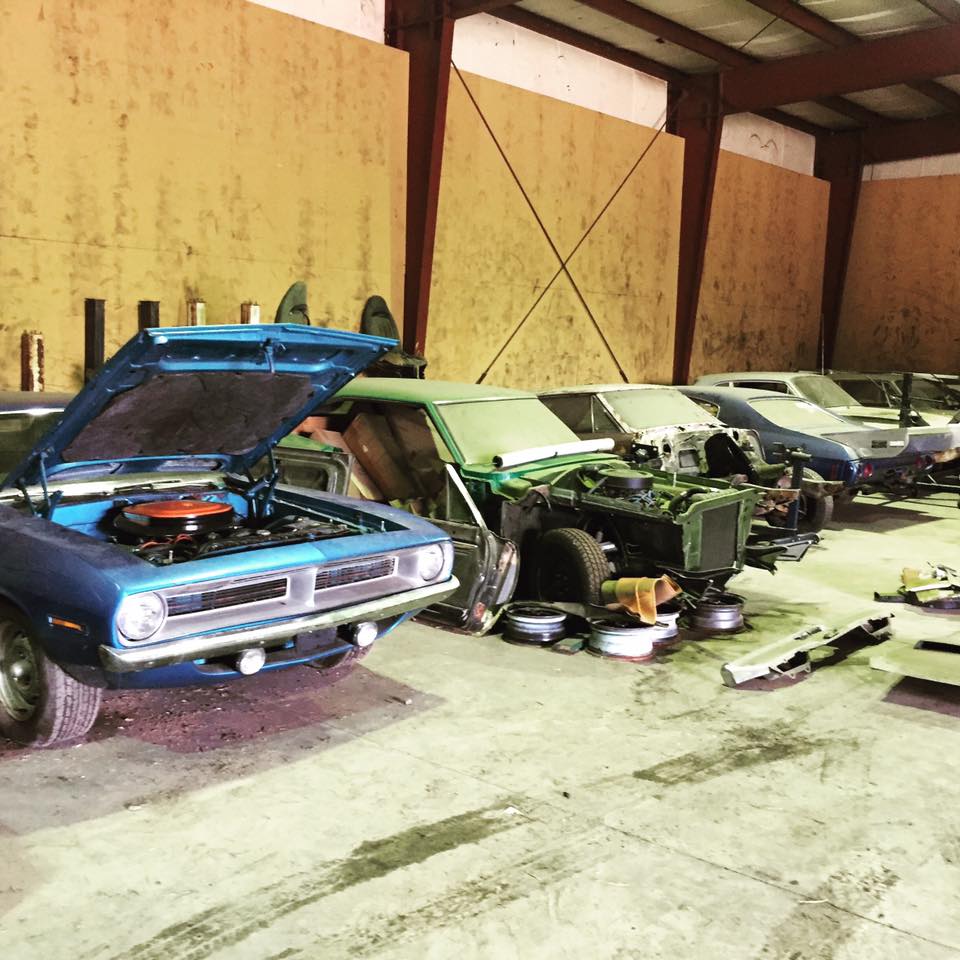 collection of classic muscle cars pre-restoration
