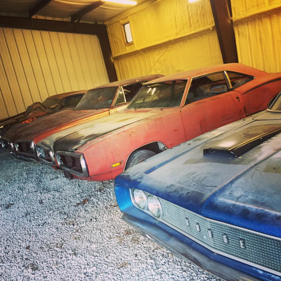 collection of classic muscle cars before restoration